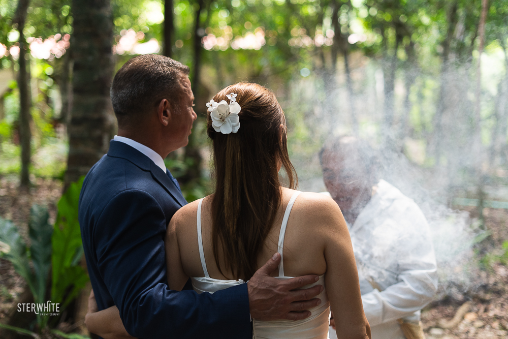 Bride and groom being purified with copal before entering the cenote