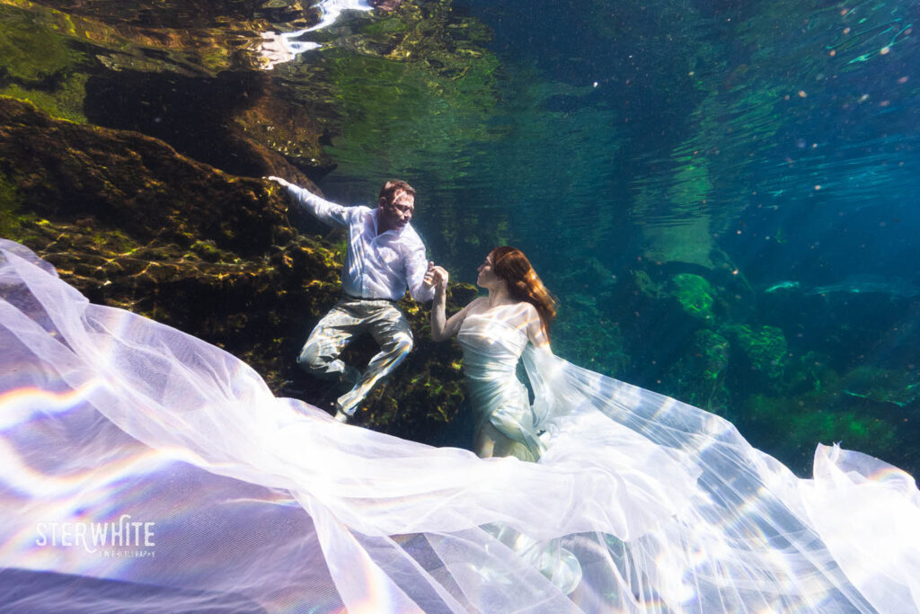 Underwater wedding photography in a cenote in Riviera Maya during a trash the dress session